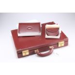 A Cartier briefcase together with a boxed coin purse and boxed address book