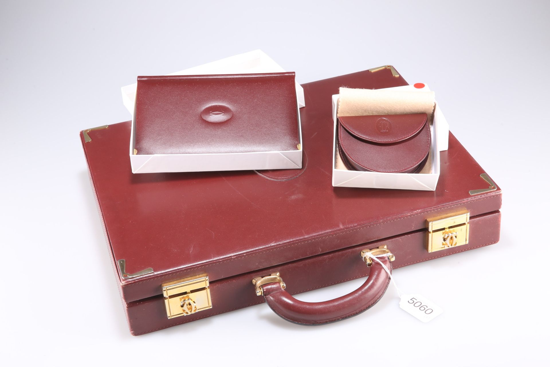 A Cartier briefcase together with a boxed coin purse and boxed address book