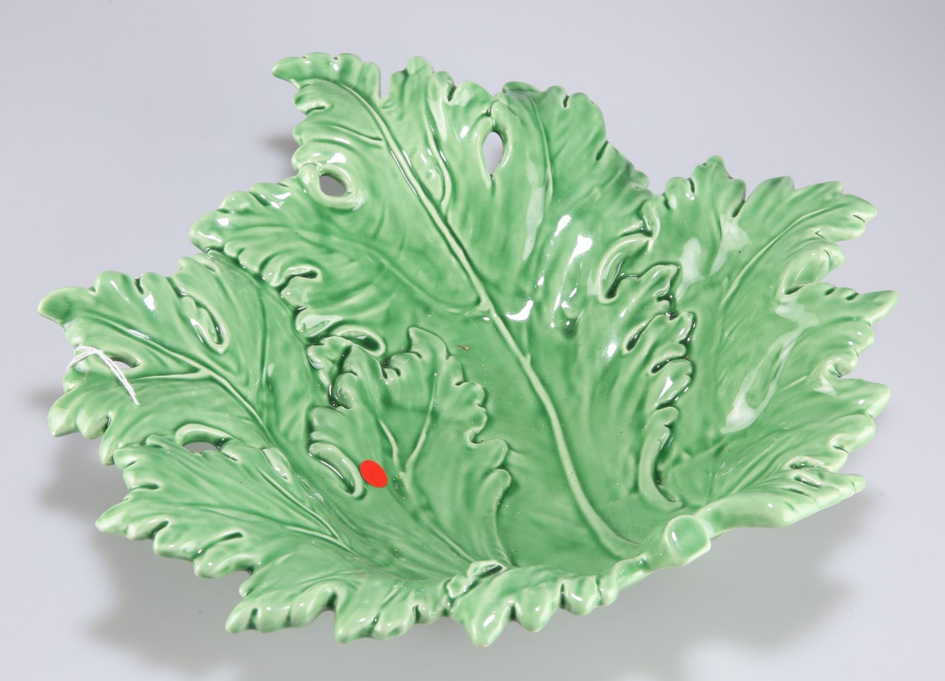 A Continental green glazed pottery leaf dish, 32cm