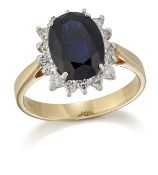 AN 18 CARAT GOLD SAPPHIRE AND DIAMOND CLUSTER RING