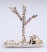 AN ELIZABETH II CAST SILVER NOVELTY RING TREE