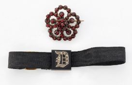 A 19TH CENTURY BOHEMIAN GARNET BROOCH AND AN ONYX AND DIAMOND MOURNING BAND