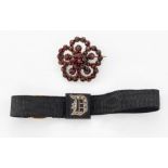 A 19TH CENTURY BOHEMIAN GARNET BROOCH AND AN ONYX AND DIAMOND MOURNING BAND