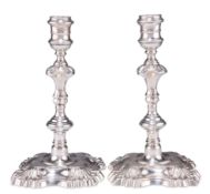 A PAIR OF GEORGE II CAST SILVER CANDLESTICKS