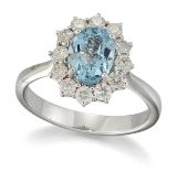 AN 18 CARAT WHITE GOLD AQUAMARINE AND DIAMOND CLUSTER RING