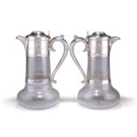 A PAIR OF VICTORIAN SILVER-MOUNTED CLARET JUGS