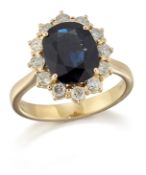 AN 18 CARAT GOLD SAPPHIRE AND DIAMOND CLUSTER RING