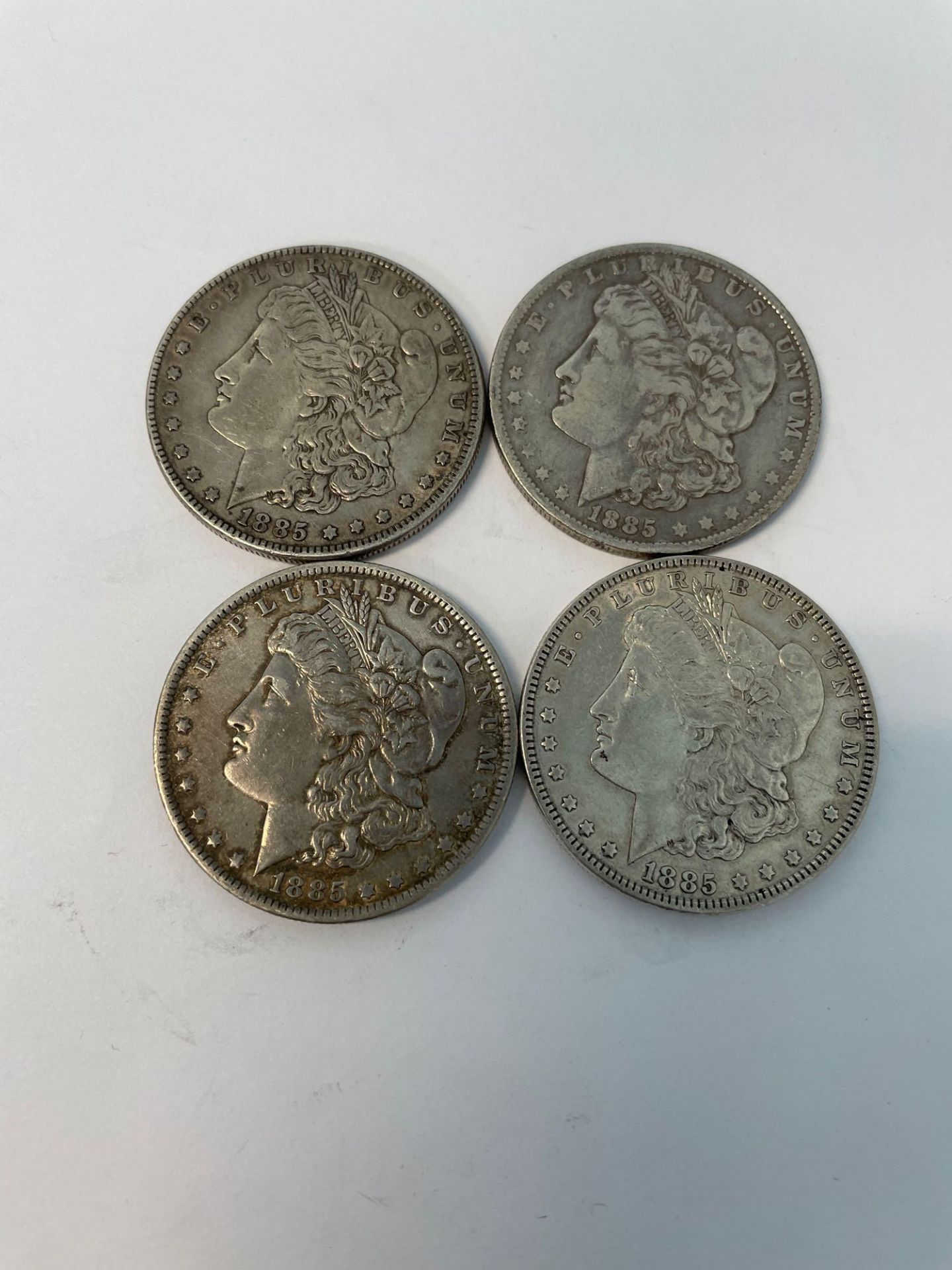 4 1885 Morgan Silver Dollars