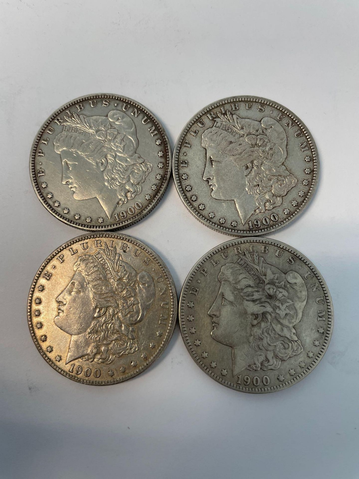 4 1900 Morgan Silver Dollars