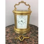 19th c Scottish retailed oval ornate carriage clock, dial marked "Leith Street Edinburgh". 13cm x 11