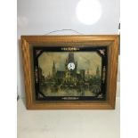 Framed picture of European town with clock set to