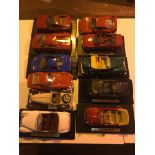 Eleven large Burago die-cast car models.