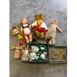 Box of vintage dolls, a bear with hump back and growler and childs ceramic tea set.