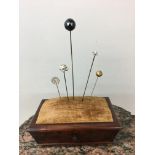 Art nouveau hat pins and mahogany stand.