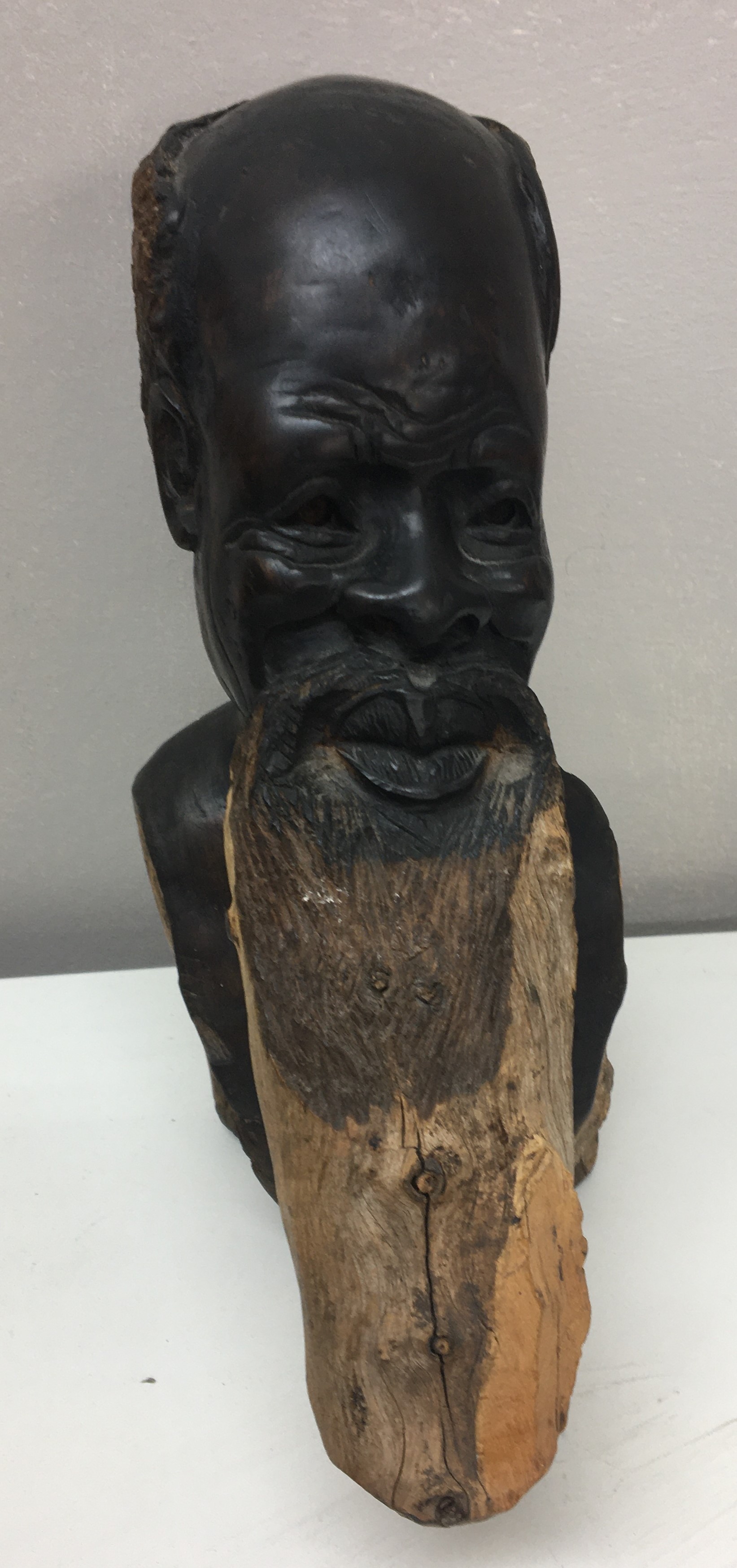 Carved wooden African figure of a bearded elder.