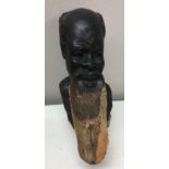 Carved wooden African figure of a bearded elder.