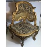 Ornate gilt embroidered rattan backed corner seat.