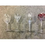 Four 19th c wine glasses, to include ribbon twist wine and grape engraved example, red and gilded ex