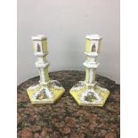 KPM C1830 porcelain candlesticks, in yellow ground with 18th c couples painted,