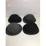 four bowler hats two with feather decoration.