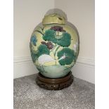 Qing dynasty coloured ginger jar on the wooden stand.