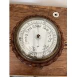 E Bacon and co Aneroid barometer in oak rope edged