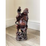 Carved Oriental figure of man and monkeys 28cm x 1