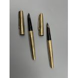 Two gold plated parker Fountain pens.
