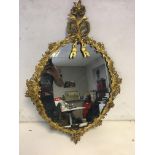 Gilt floral metal framed mirror.