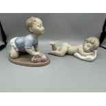 Lladro Baby Pushing Car and Laying on Pillow