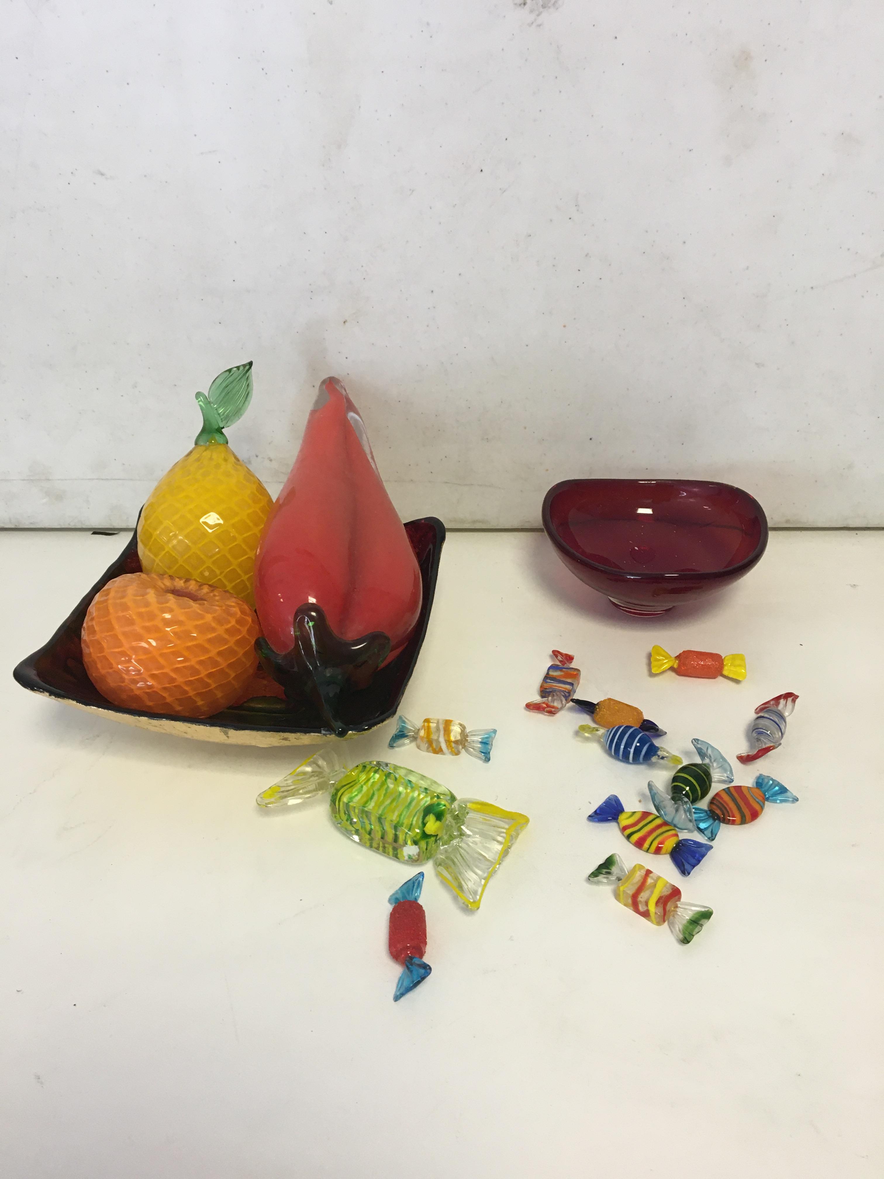 Glass fruit and glass sweets in bowl.