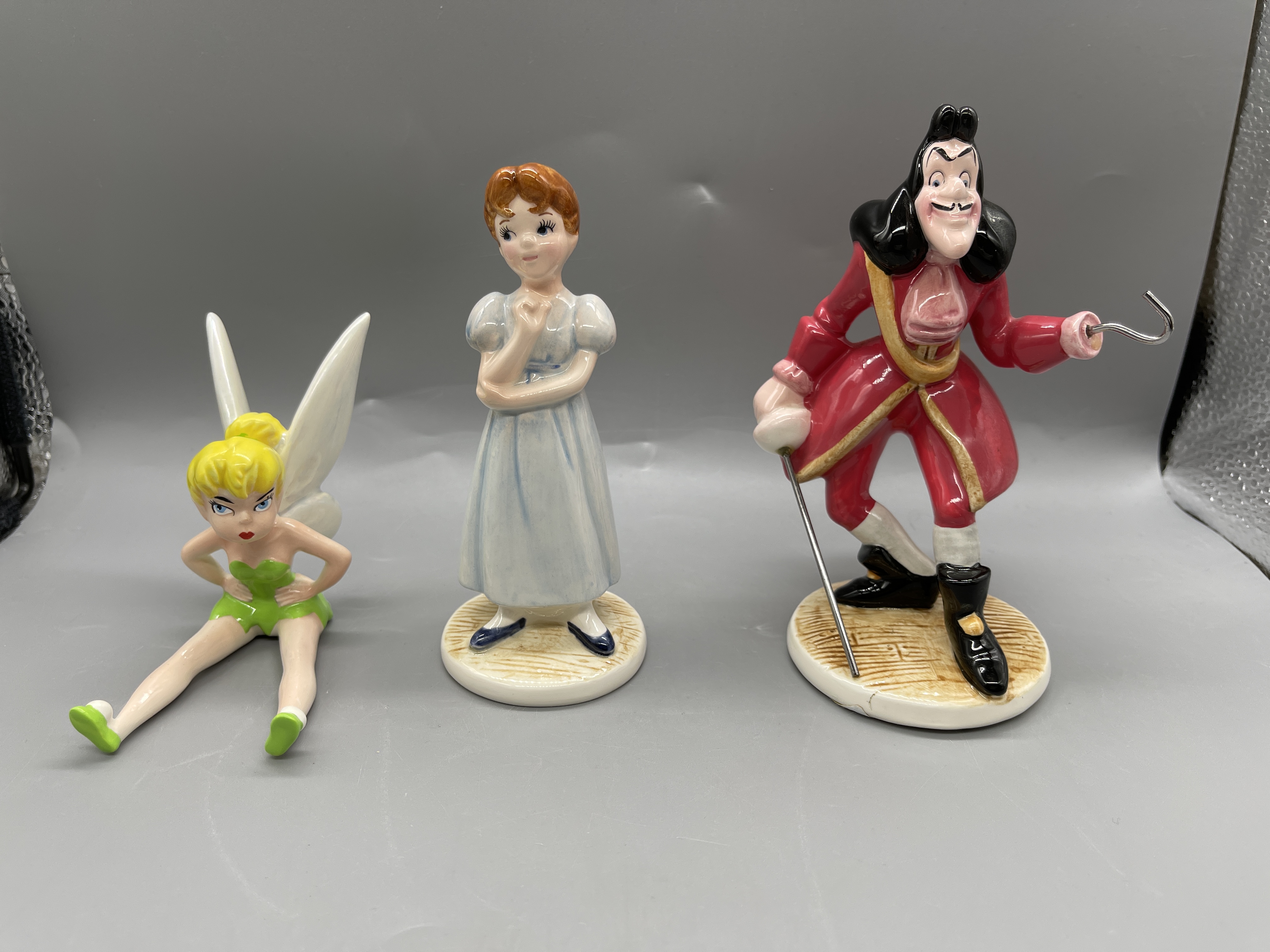 THREE CERAMIC PORCELAIN DISNEY FIGURINES; TINKERBE