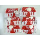COCA-COLA: A group of six Christmas Hats sealed in packets (6)