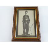 A framed, signed black/white photograph of CHARLIE CHAPLIN - together with supporting paperwork