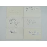 JAMES BOND: A mixed group of signed cards comprising: ROGER MOORE, DONALD PLEASANCE, JUDI DENCH,