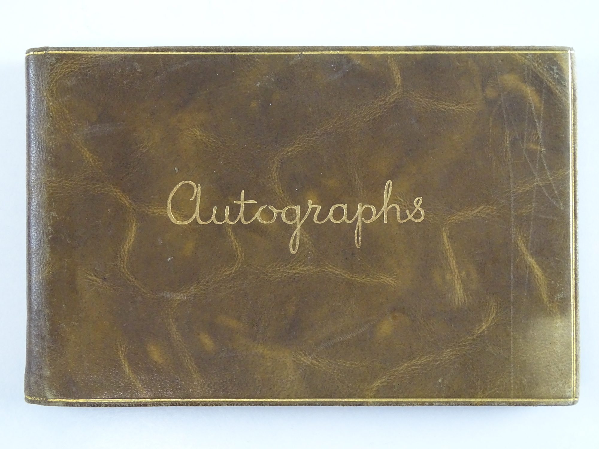 A vintage autograph book containing a NOEL COWARD autograph in addition to many other unknown