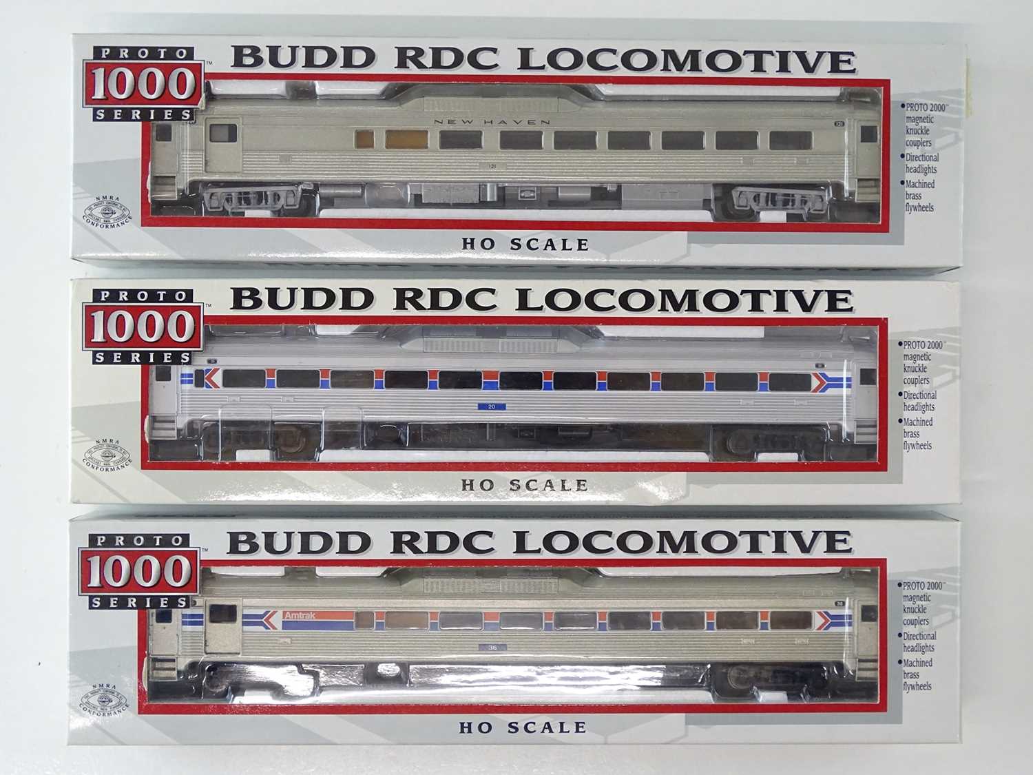 A group of PROTO 1000 HO Gauge American Outline Budd diesel railcars in Newhaven and Amtrak liveries