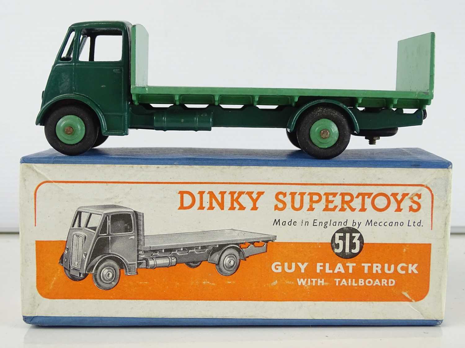 A DINKY Supertoys 513 Guy Flat Truck with Tailboard - dark green cab and chassis and mid-green