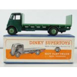 A DINKY Supertoys 513 Guy Flat Truck with Tailboard - dark green cab and chassis and mid-green