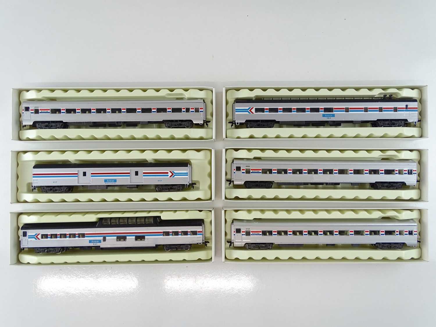 A group of RIVAROSSI HO Gauge American Outline coaches together with a baggage car all in Amtrak