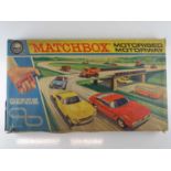 A vintage MATCHBOX M2 "Motorised Motorway" slot racing set, contents appear complete and with