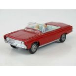 A CORGI 246 Chrysler Imperial in red with pale blue interior, with passengers and golf trolley -