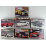 A group of unbuilt 1:25 scale plastic car kits, primarily American examples by AMT (contents