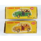 A pair of DINKY 254 Austin Taxis comprising examples in yellow and green/yellow - F/G in G boxes (