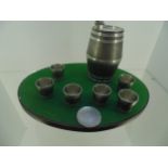 Table with 6 shot glasses and barrel