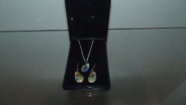 silver opalescent pendant and earrings .