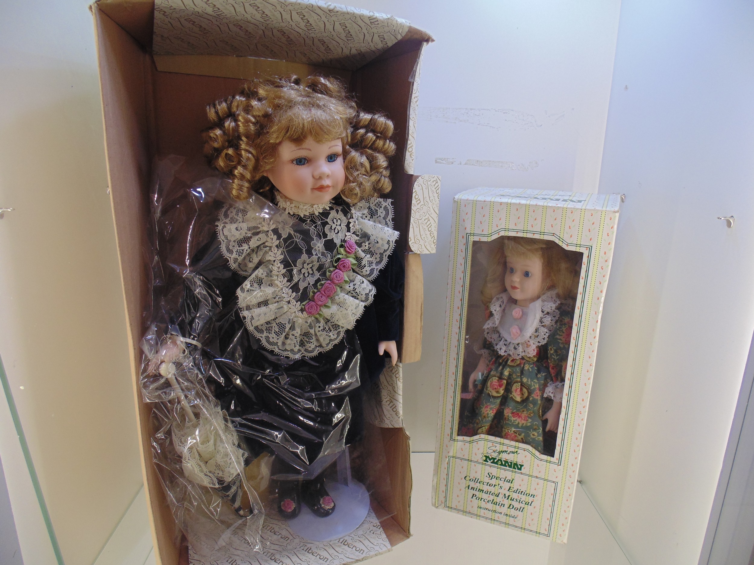 2 boxed porcelain Dolls