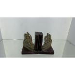 a pair of metal ship and carved wood book ends