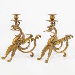 A pair of brass candlesticks in the shape of a dragon with wings. The first half of the 20th centur