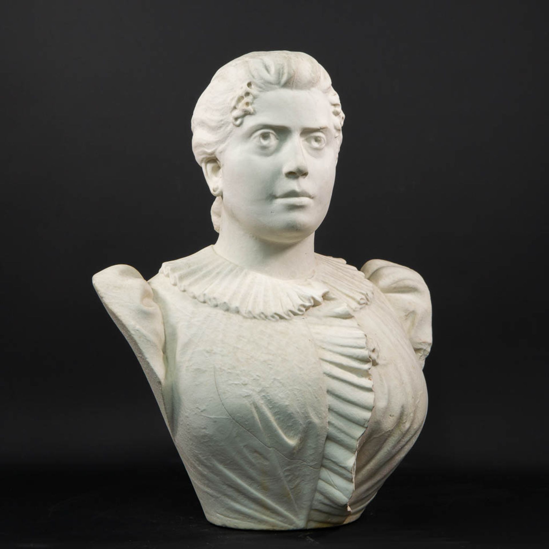 A Large bust sculptured from white Carrara marble illegibly marked on the left shoulder.